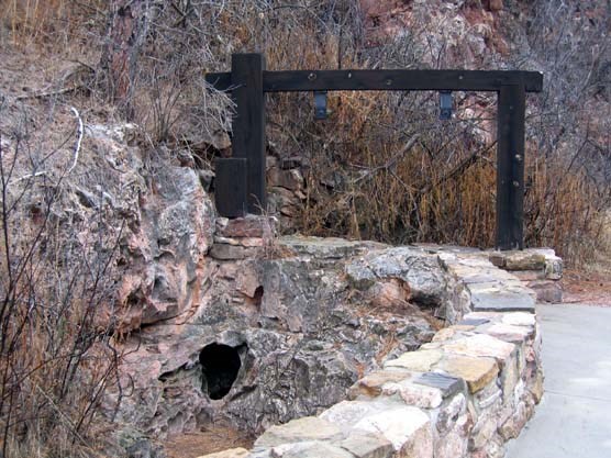 Wind Cave natural entrance with empty sign holder beside it