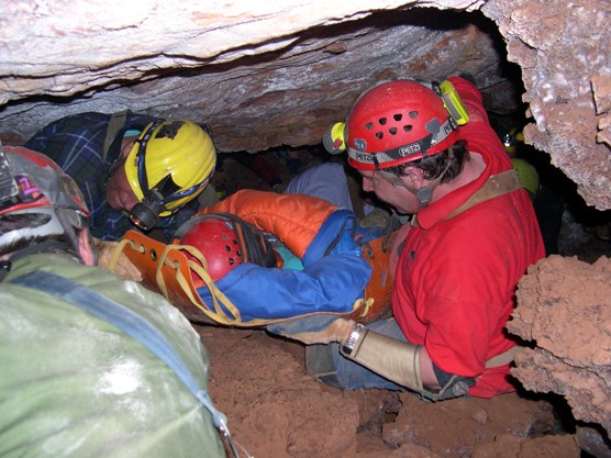 Park employees practice carrying a “patient”, seen here wrapped in a sleeping bag and carried on a plastic litter, from deep in Wind Cave.