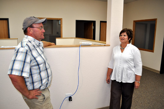 Brian Spitzer, President of Spitzer Construction, Inc., discusses the renovated office building with Andrea Kern, Human Resource Officer for the West SHRO.