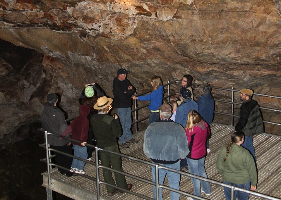 Tour in Jewel Cave low res Cave tour in Jewel Cave standing on metal platform looking at the cave.