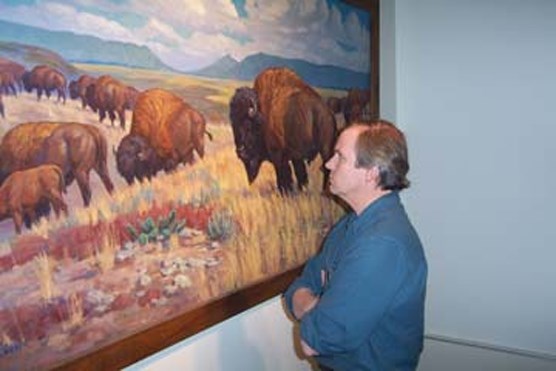 Visitor viewing painting in Wind Cave National Park visitor center.