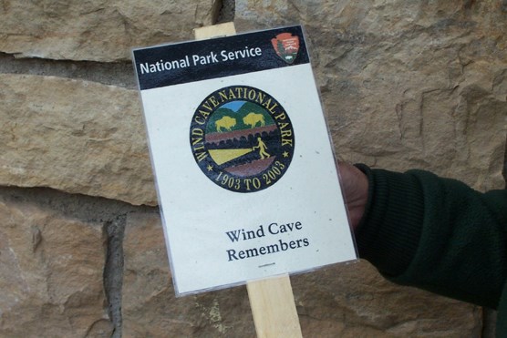 Photograph of grave decoration honoring deceased individuals who aided in the development and growth of Wind Cave National Park.