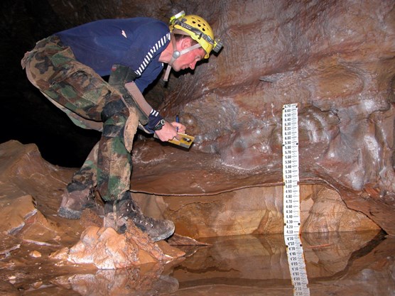 Physical Science Technician Marc Ohms recalibrating the water gauge used to monitor lake level at the bottom of Wind Cave.