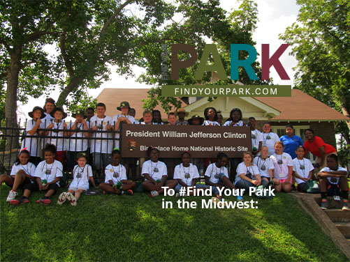 Youth on the front lawn of the President Clinton Birthplace Home National Historic Site visitor center.