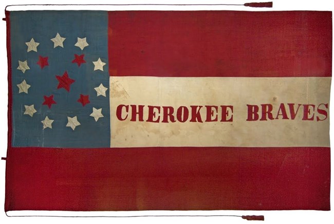Historic battle flag includes three stripes, 11 white stars, 5 red stars, and the words Cherokee Braves