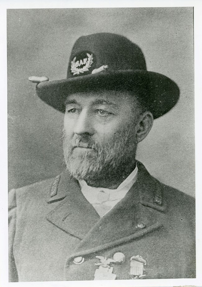 An older man in military uniform displays medals on his jacket