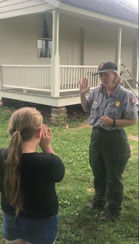 A ranger giving the junior ranger pledge A ranger giving the junior ranger pledge