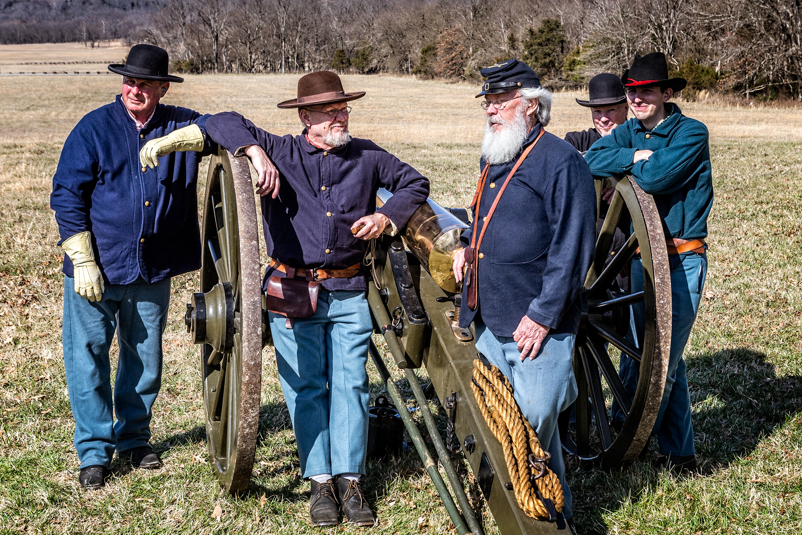 Volunteer members of artillery crew Men in reproduction Union Army uniforms stand next to a cannon