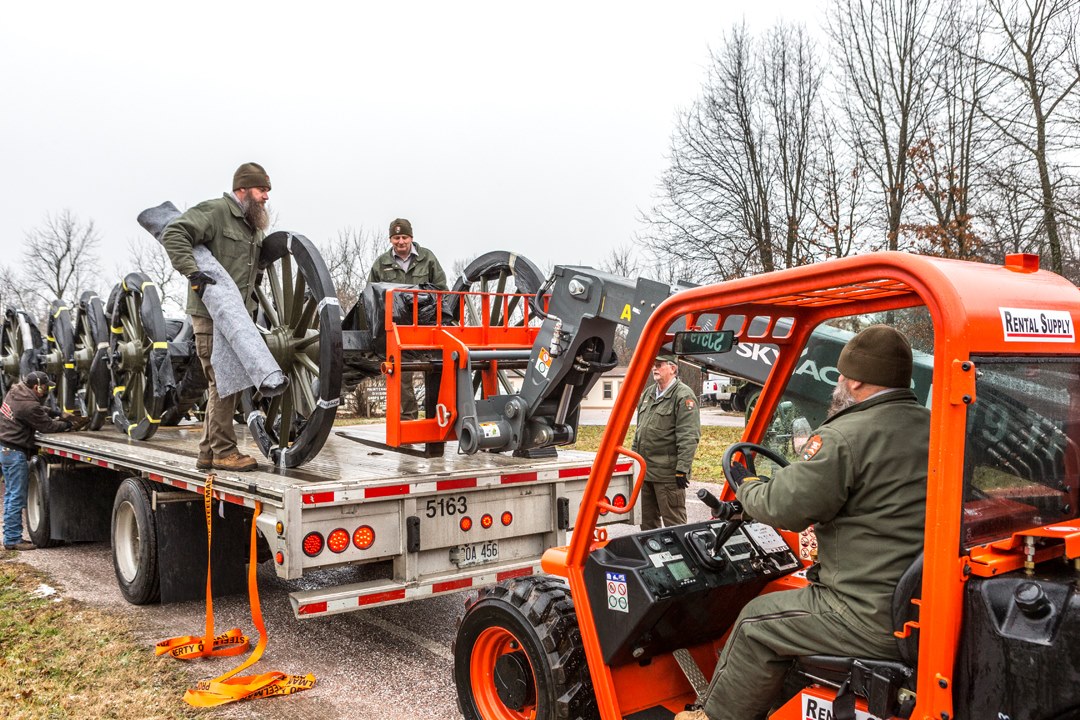 Maintenance team unloads equipment using a forklift Man uses forklift to unload equipment from truck