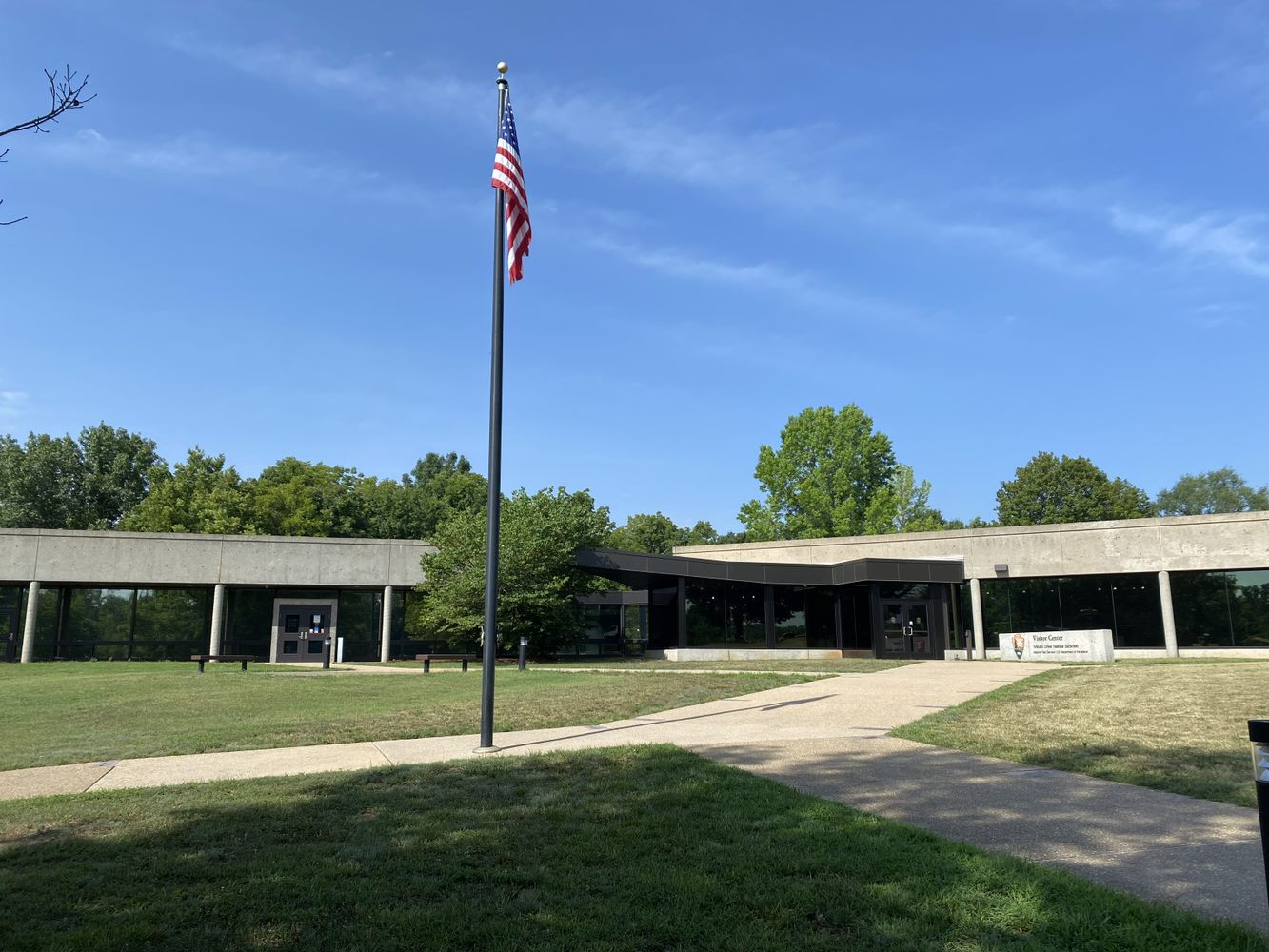 Wilson's Creek Visitor Center building with flag and lawn in foreground
