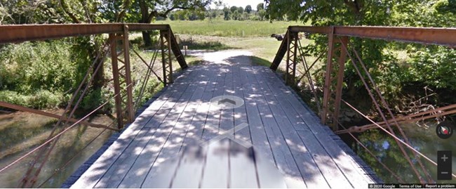 Steel bridge crosses Wilson's Creek