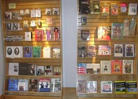 Several books sitting on display shelves on a wall.
