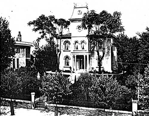 Property to south of Taft home A large two-story home with a towering steeple-like structure on the front of it and tall trees and lush vegetation in the front yard