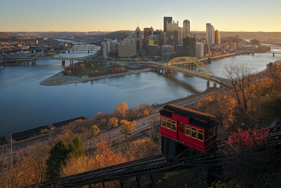 A red trolley goes down the incline in early morning