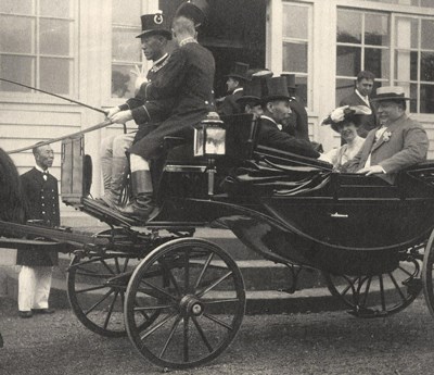 Taft and Japanese hosts in carriage A group of people in a carriage with two men seated up front and one tipping his hat