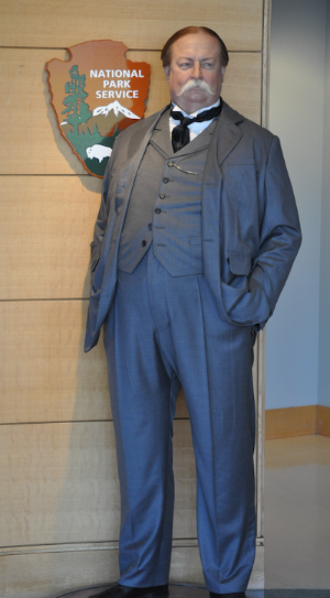 WaxTaft A wax statue of William Taft in a three piece suit wearing a wide handlebar mustache standing in front of the National Park Service arrowhead