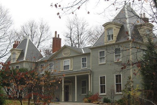 A large house with many windows and multiple-peaked roof