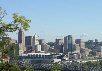 Several tall buildings in the background and a large stadium in the foreground.