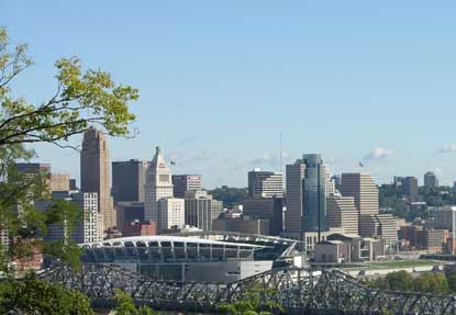 Several tall buildings in the background and a large stadium in the foreground. Several tall buildings in the background and a large stadium in the foreground.