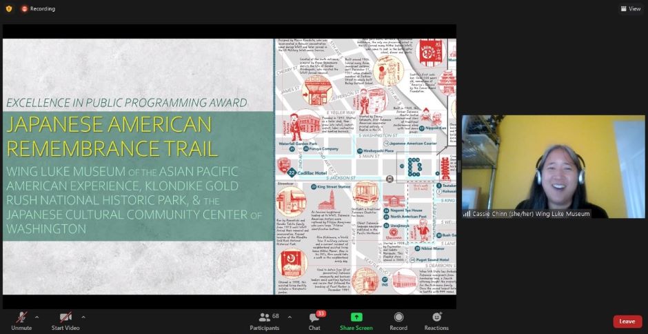 Wing Luke Museum Deputy Executive Director Cassie Chinn Accepts Award Screen shot of virtual awards ceremony with image of awardees, an illustrated map, and a person talking
