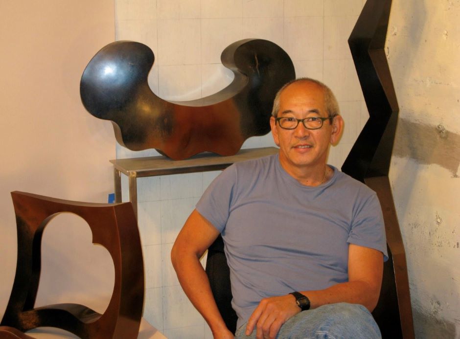 Gerard Tsutakawa The artist seated in front of a few of his smaller works