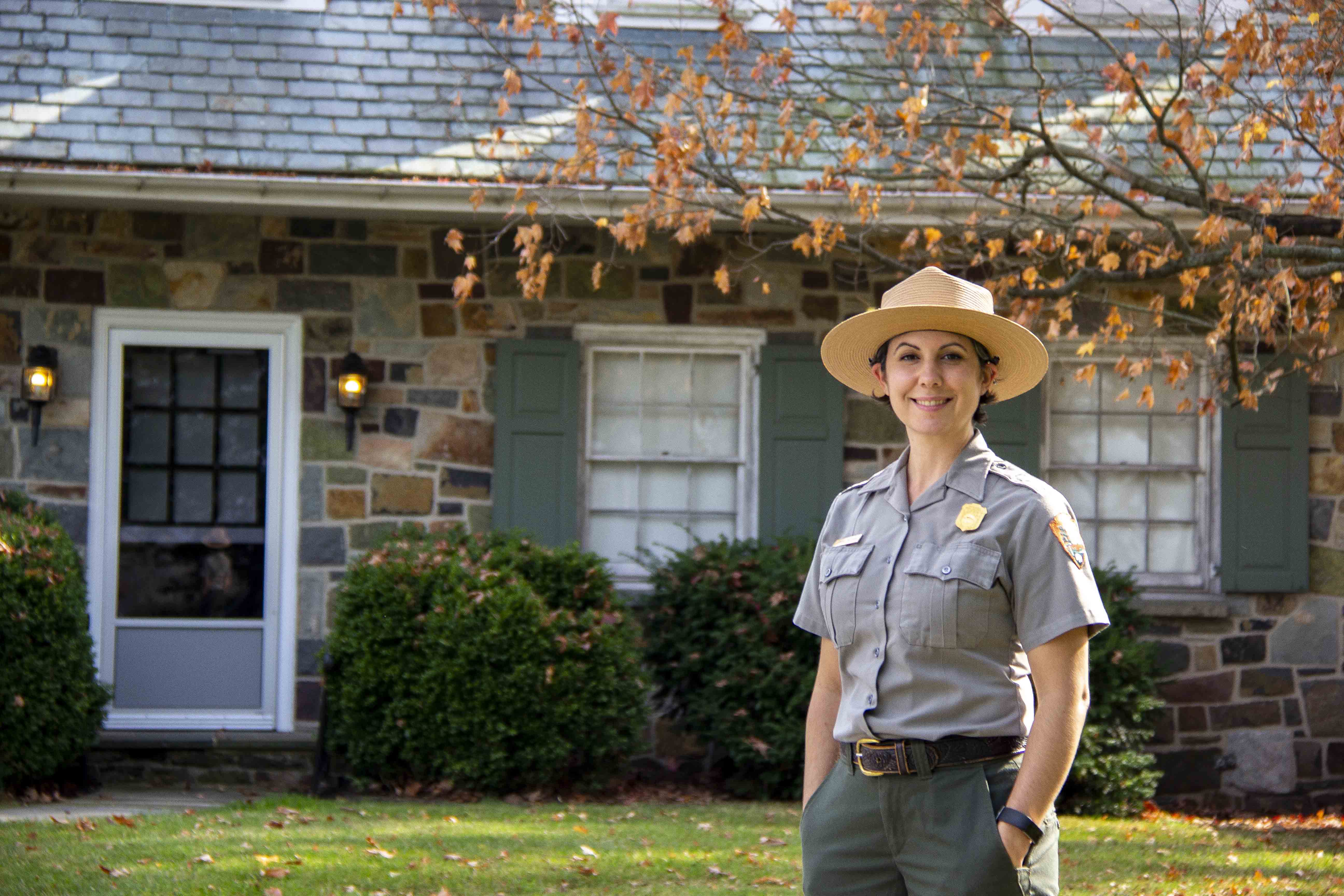 Ahna Wilson_10-28-20_0002 a woman park ranger stand in front of a stone building