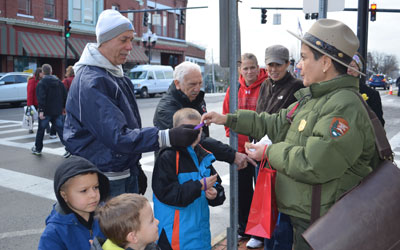 Ranger Ami shares bracelets with festival participants.
