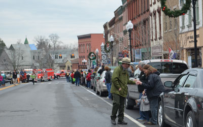 Ranger Jeff shares gold bells with parade participants.