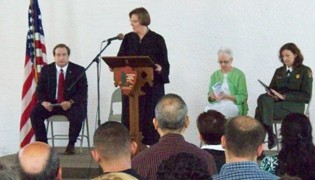 The Honorable Marian Payson presides over the citizenship ceremony at the park.