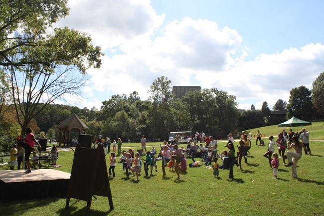 Group doing dance fitness activity in meadow