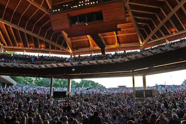 A stage view of a packed Filene Center during a performance.