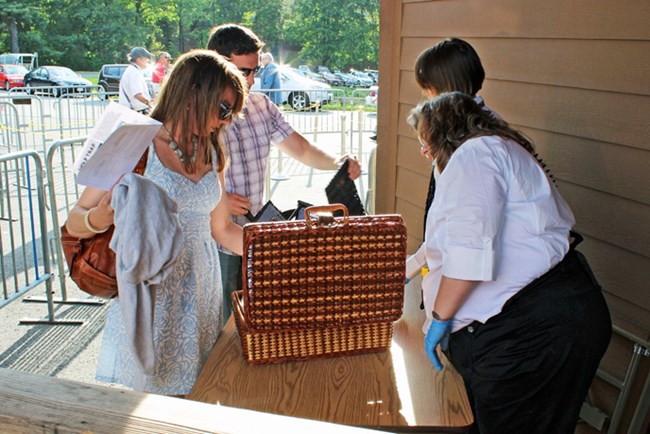 Couple having basket inspected for Filene Center performance Couple having basket inspected for Filene Center performance