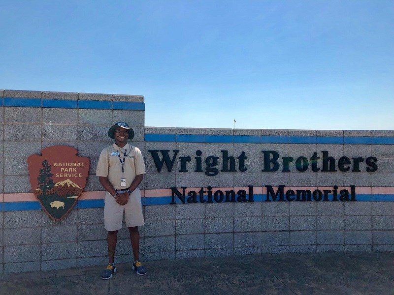 2018 Intern Joshua Tillman Intern Joshua Tillman standing at the entrance to Wright Brothers National Memorial.