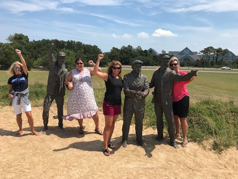 Dare County Teachers Pose with Wright brothers statues. Dare County Teachers Pose with Wright brothers statues.