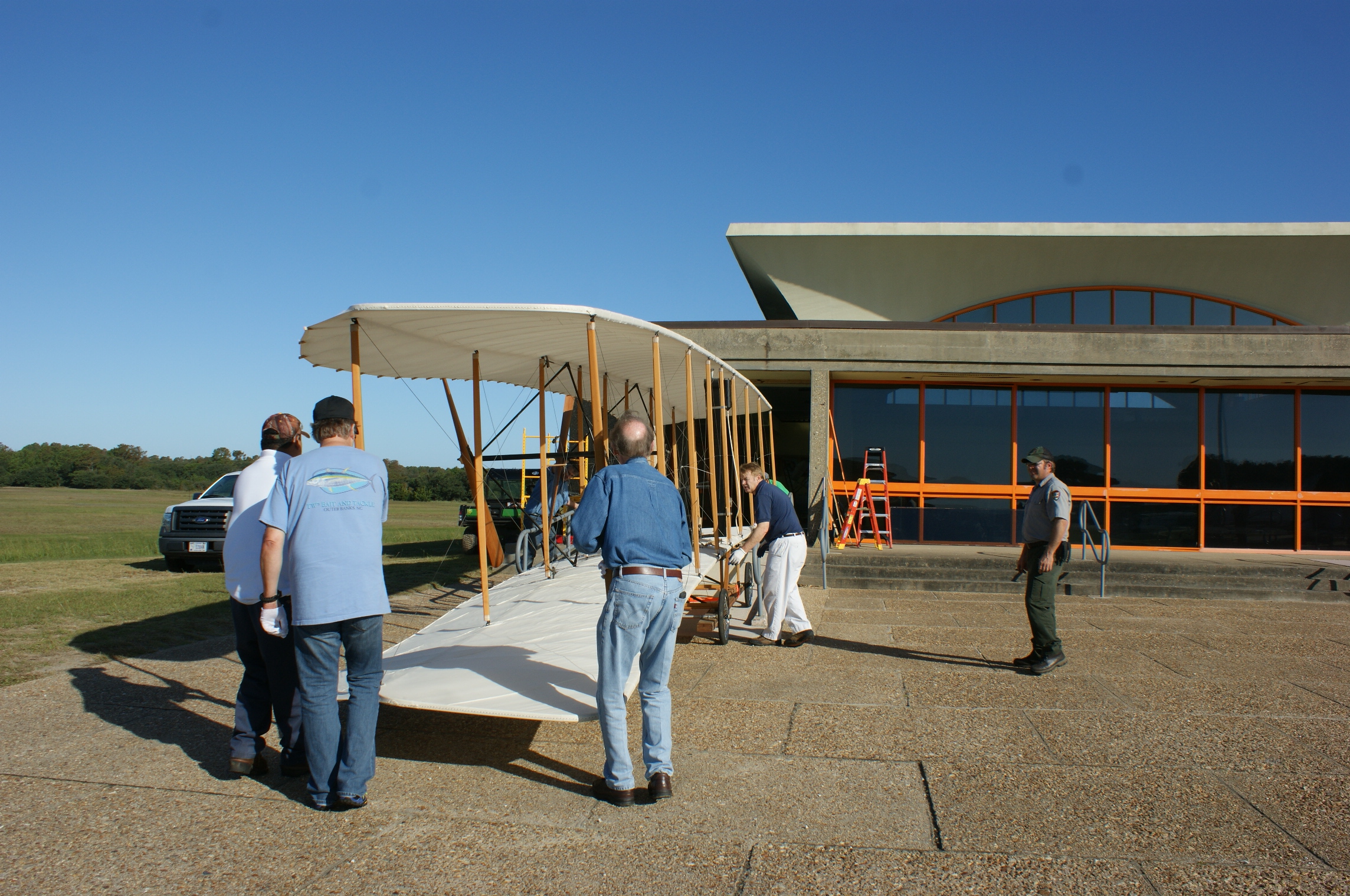 Wright Brothers 1903 Flyer Move from Visitor Center Moving crew carefully moving the Wright brothers 1903 Flyer from the visitor center.