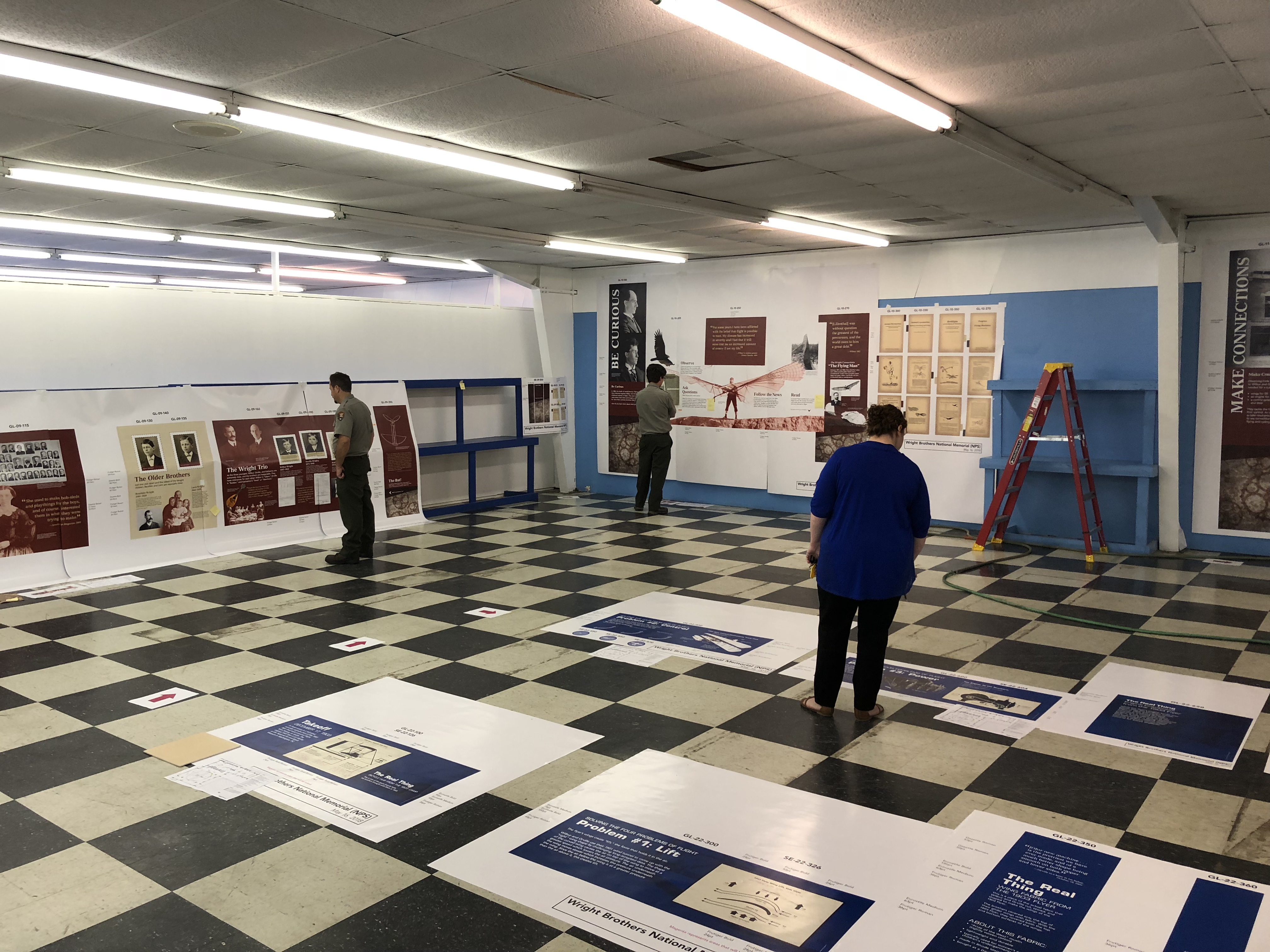 NPS Staff Reviewing New Exhibits for Wright Brothers Visitor Center National Park Service staff reviewing small section of exhibits during the review phase of the exhibit project.