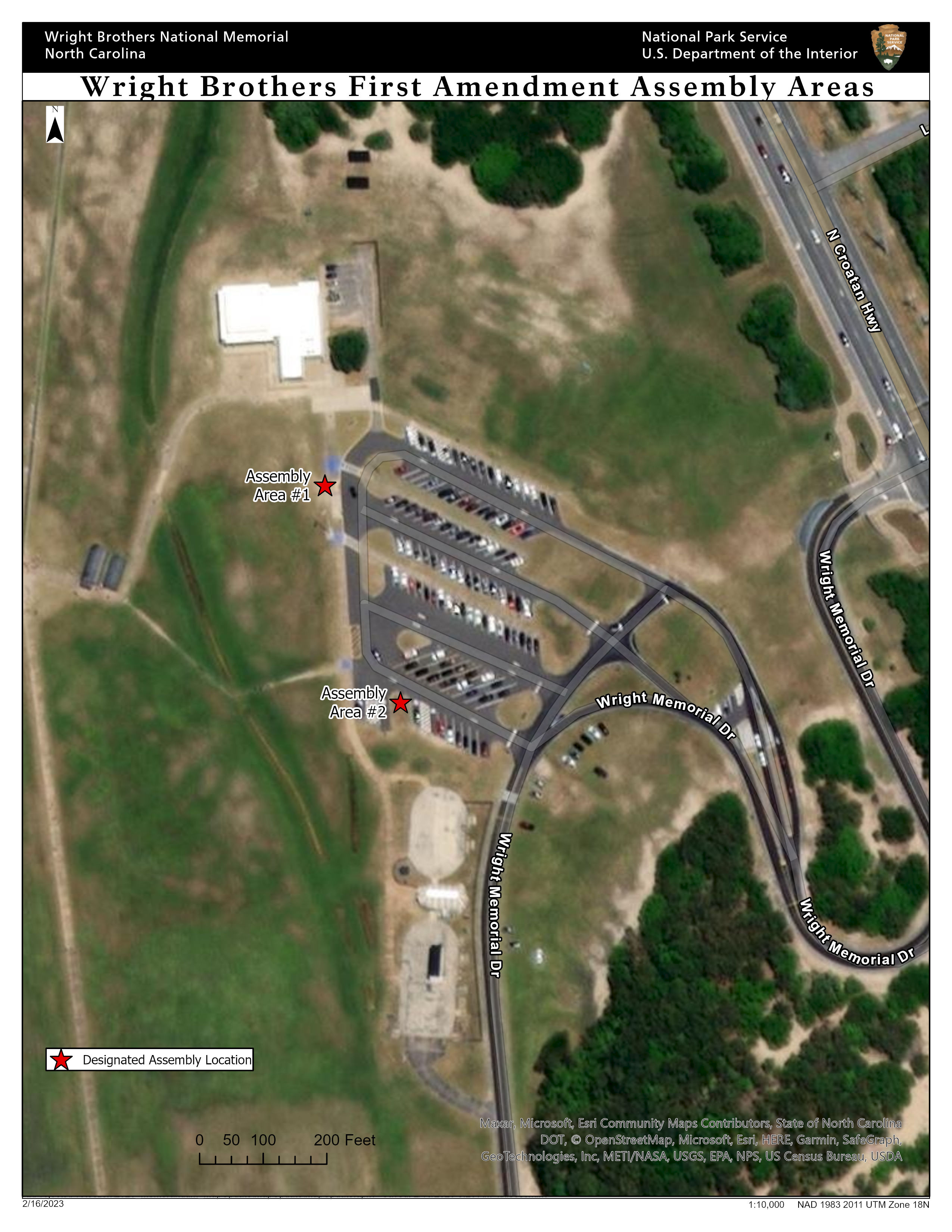 Overhead map of Wright Brothers National Memorial showing two red stars near the parking lot identifying the first amendment areas. One is near the northwest corner and the other is near the southwest corner.