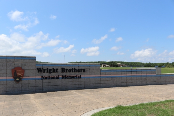 Entrance to Wright Brothers National Memorial with visitor center in background.
