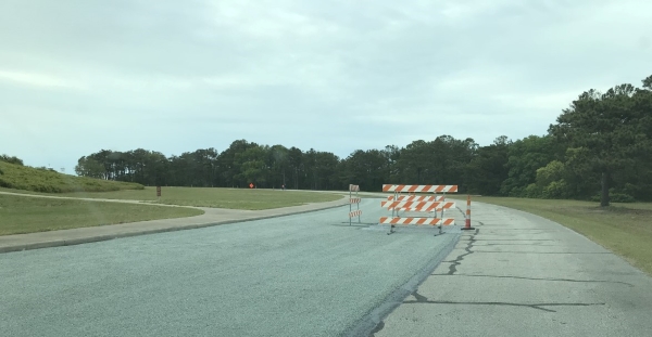 Chip and crack sealing on road at Wright Brothers National Memorial. Photo of chip and crack sealing on road at Wright Brothers National Memorial.