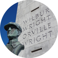 Copper bust of Wilbur Wright and the Wright Brothers Monument.