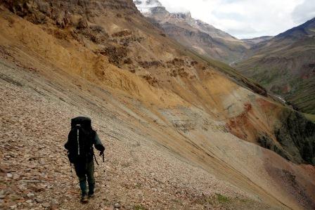 Ranger hiking across scree