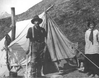 Historic photo of miner with woman in front of canvas tent.
