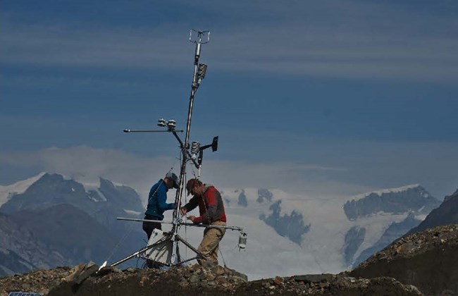Researchers installing monitoring equipment on Malaspina Glacier