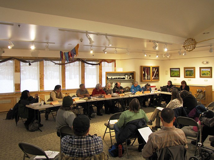 Subsistence Resource Commission members gathered around a table discussing issues. Subsistence Resource Commission members gathered around a table discussing issues.