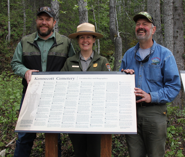 Kennecott Cemetery Dedication Pioneers of Alaska’s Al Clayton poses with National Park Service Superintendent Ben Bobowski and Interpretive Supervisor Jamie Hart at the cemetery wayside dedication ceremony. Photo Credit: National Park Service