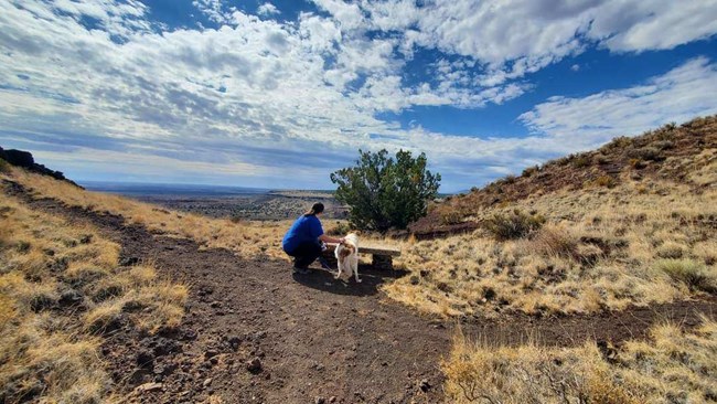 A visitor with her dog on the Doney Mountain trail.