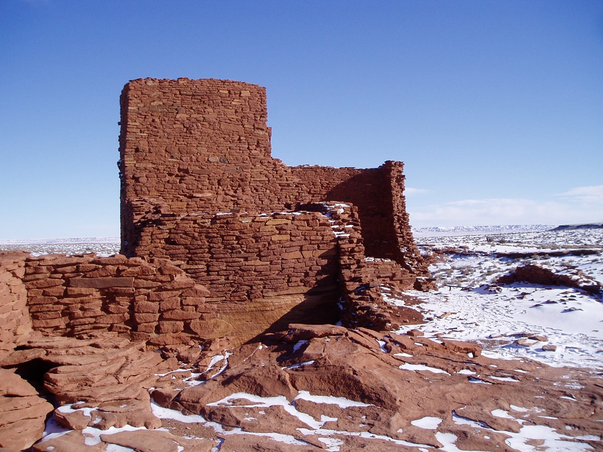 Wukoki, a 900 year old sandstone structure, with snow on the ground.