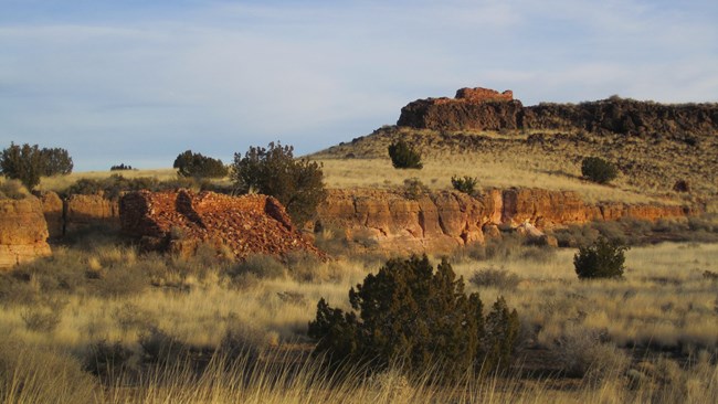Small partial pueblo structures on a small mesa.