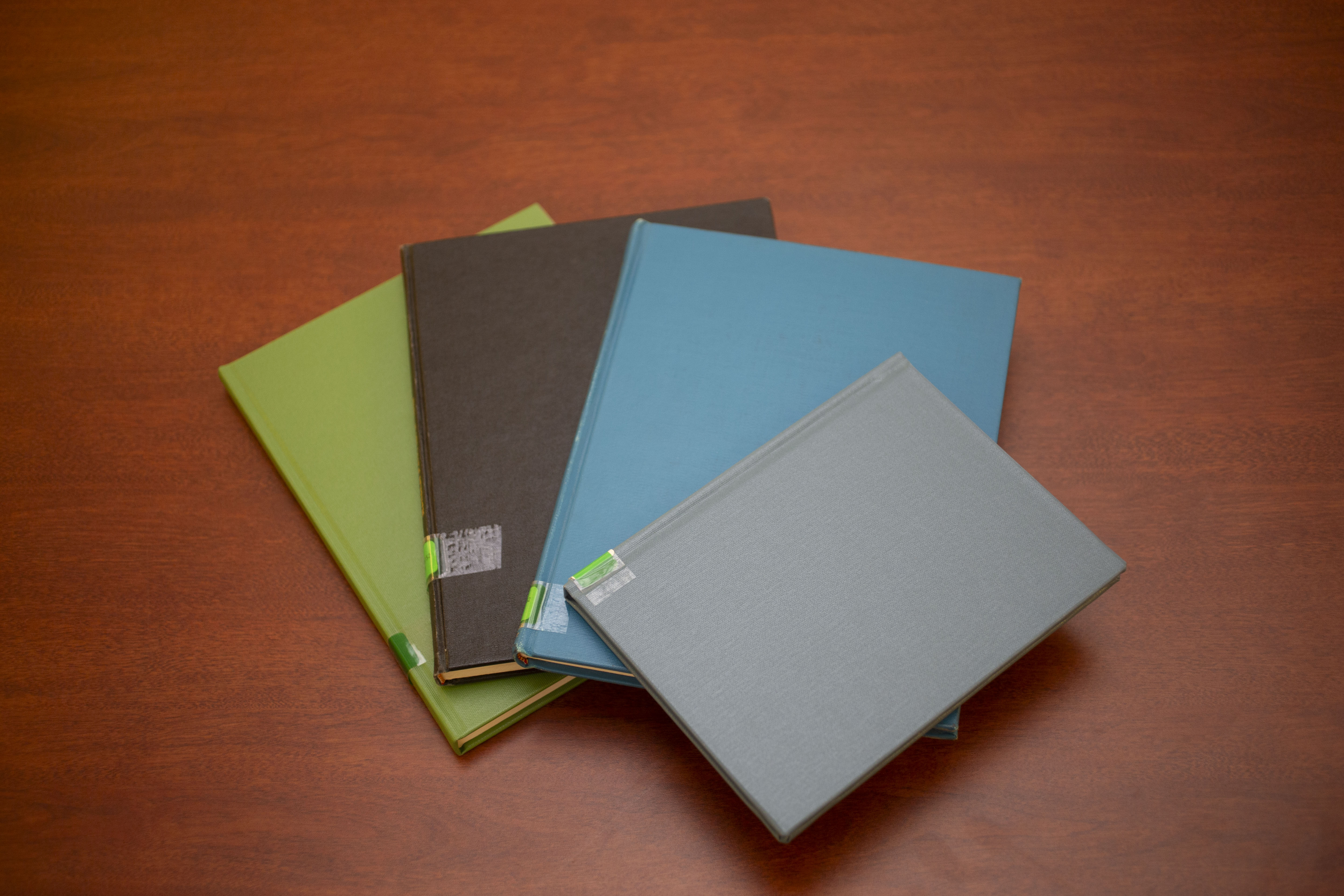 A stack of four books on a desk