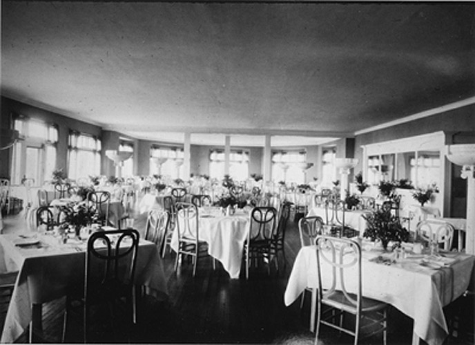 Historic black and white photo of the Lake Hotel Dining Room with tables and chairs. Circa 1930.